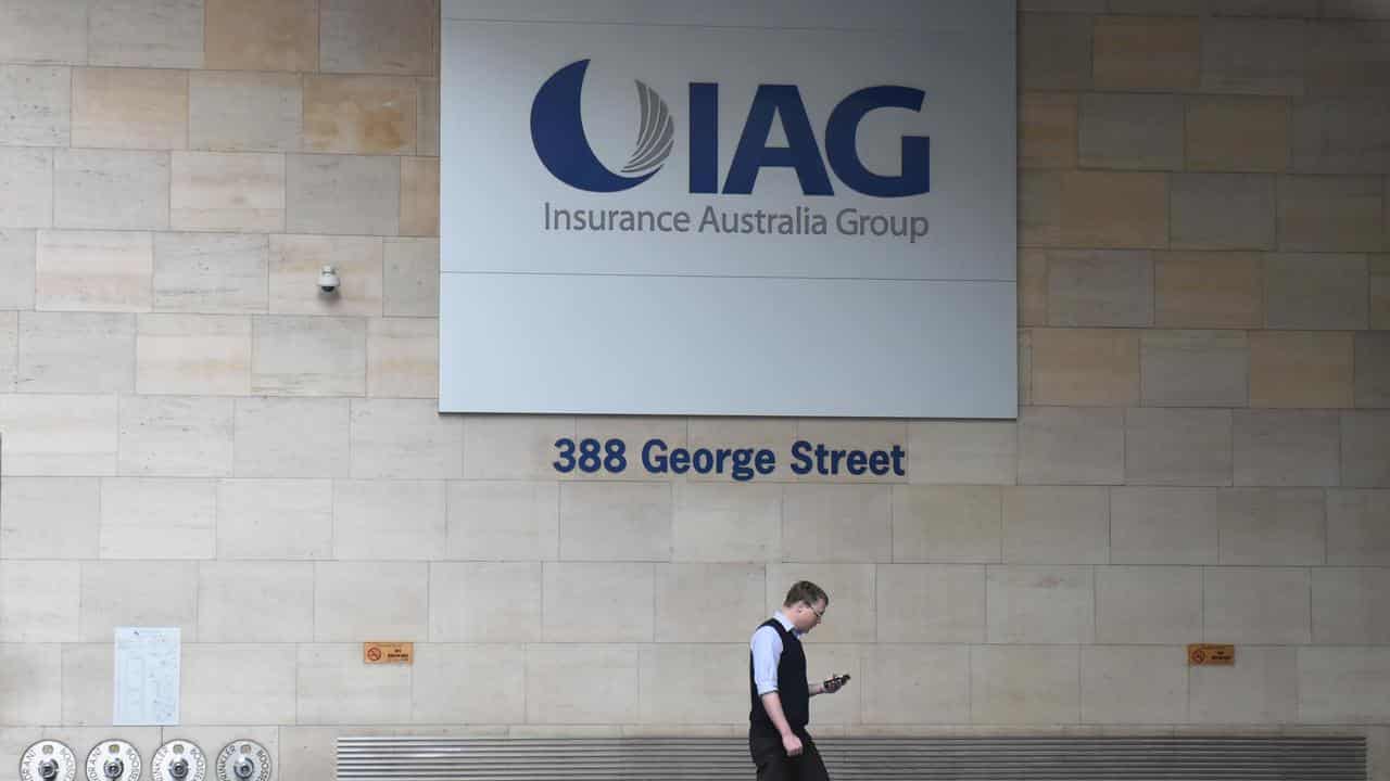 Man walks past the Insurance Australia Group head office