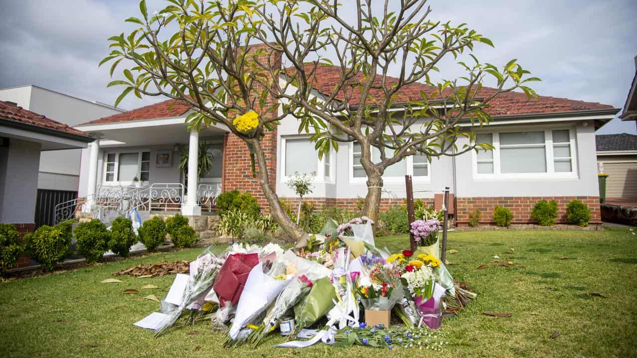 Floral tributes outside the Perth house where two women were killed.