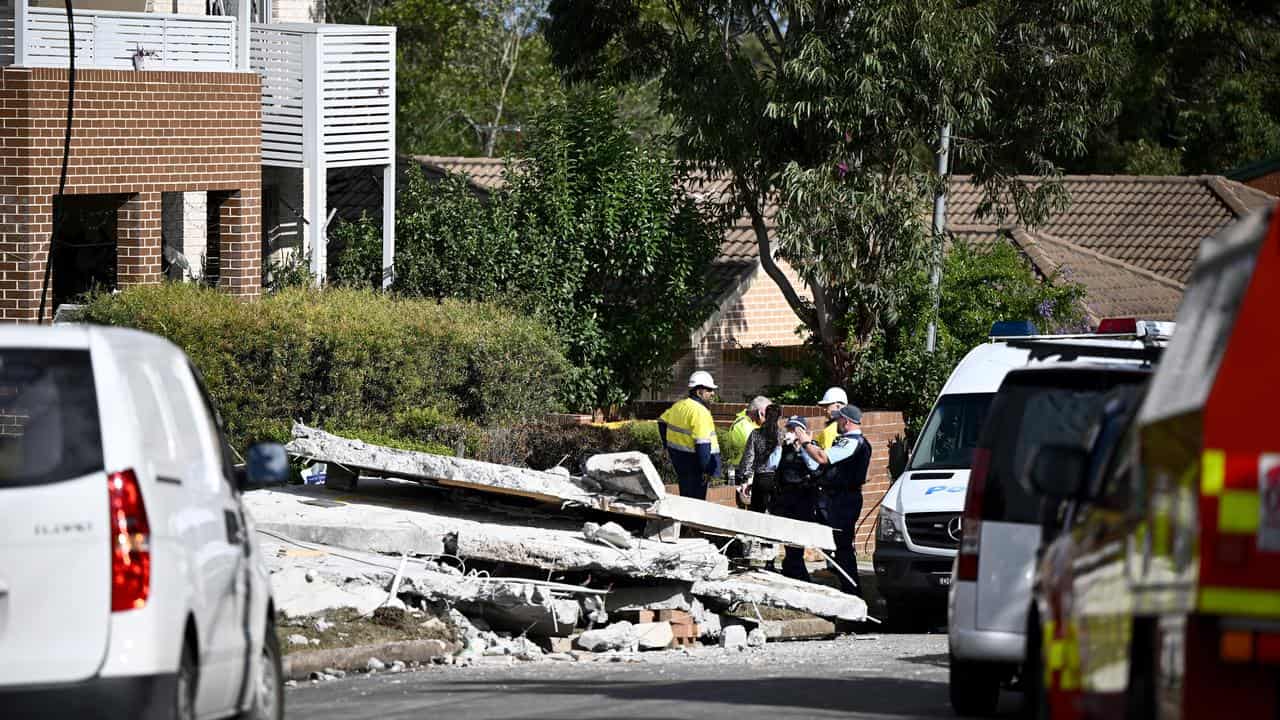 Emergency workers at the collapsed townhouse 