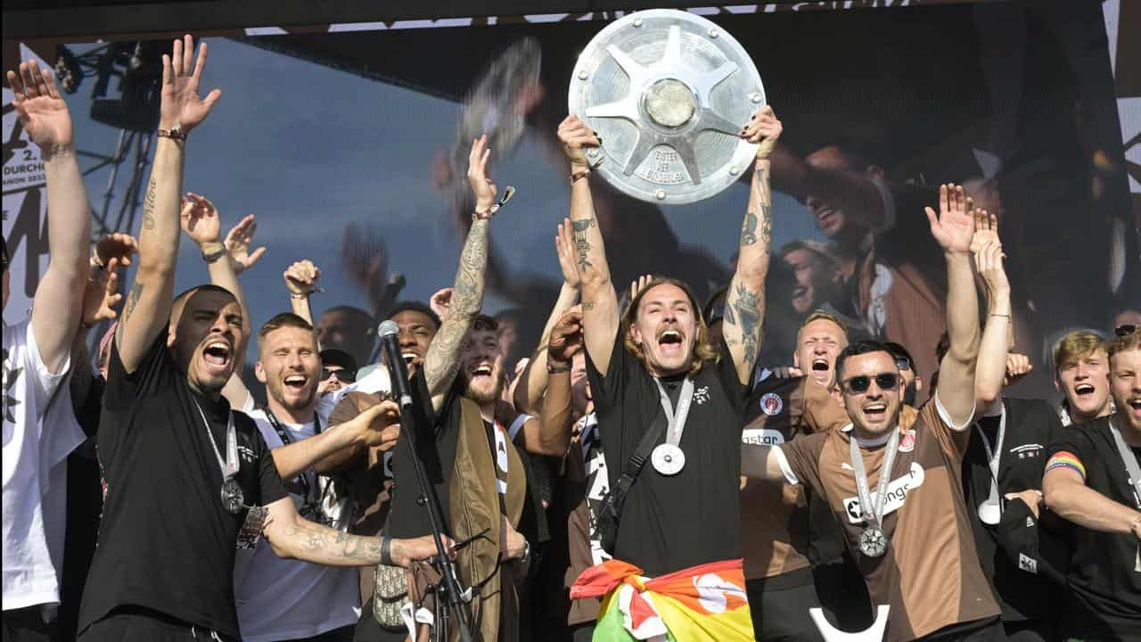 Jackson Irvine with the Bundesliga 2 trophy. 