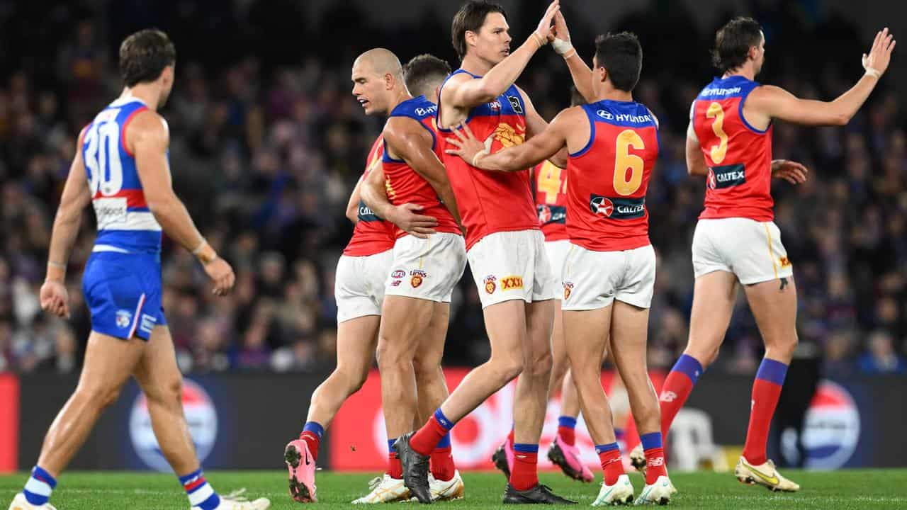 Lions players celebrate a goal.