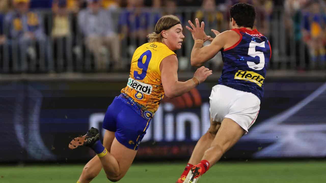 Harley Reid of the Eagles under pressure from Christian Petracca.