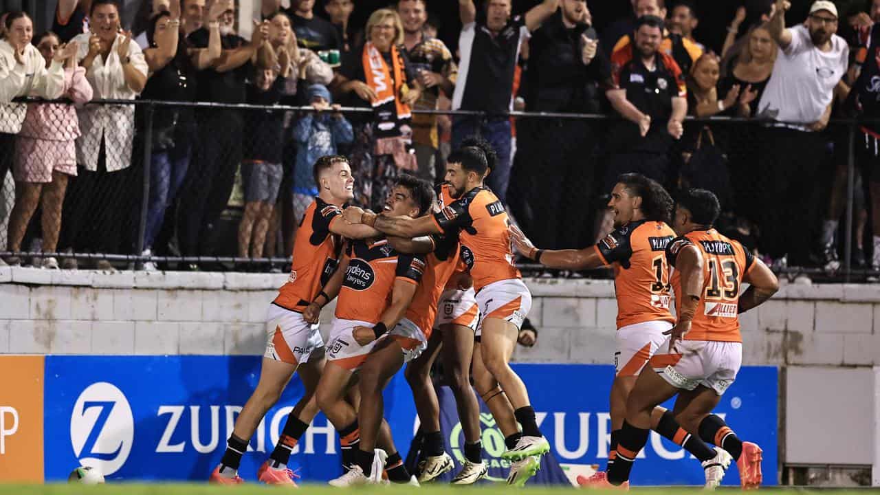 Wests Tigers players celebrate a try (file image)