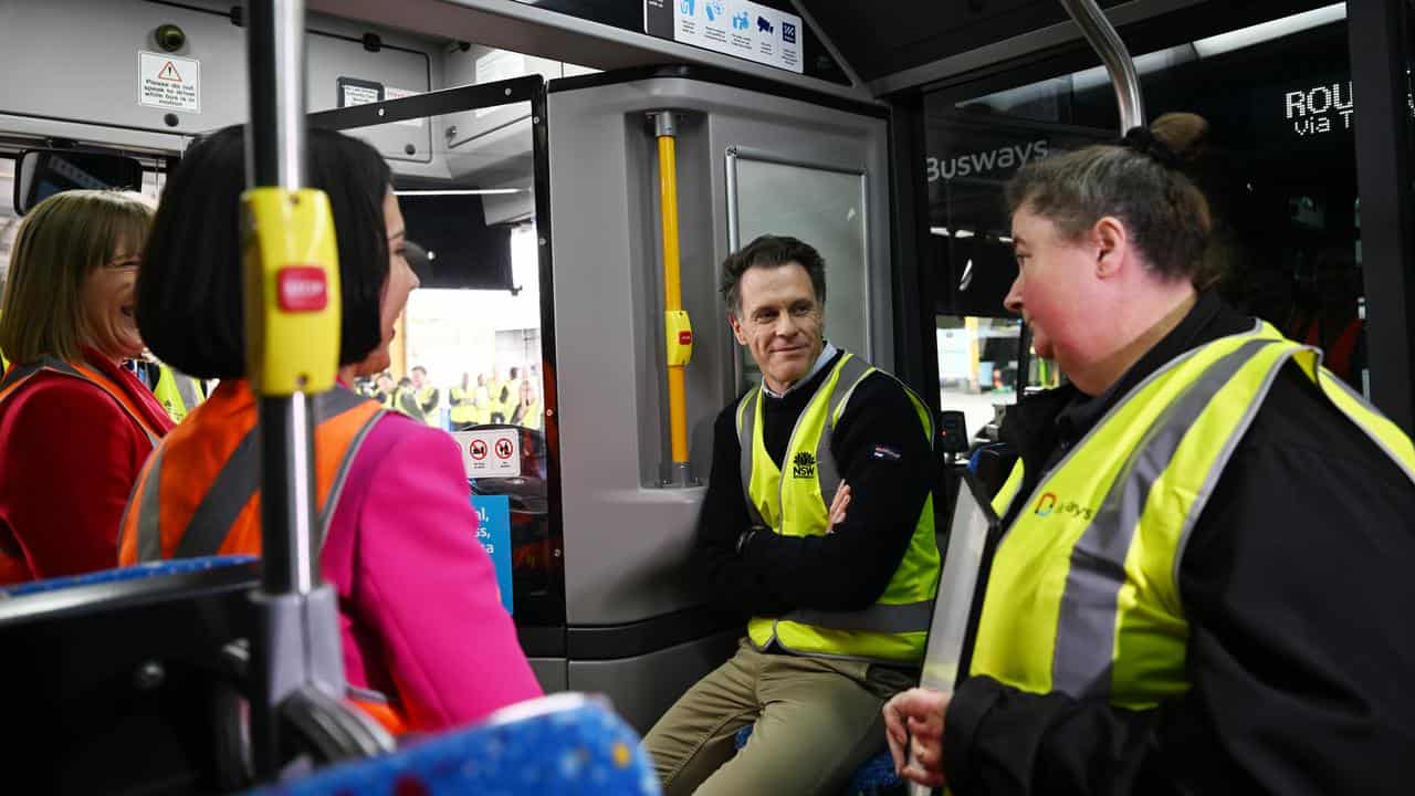 Premier Chris Minns sits on a bus.