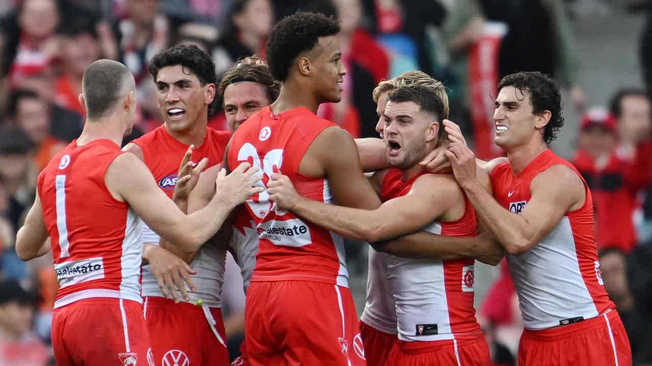 Swans players celebrating a goal.