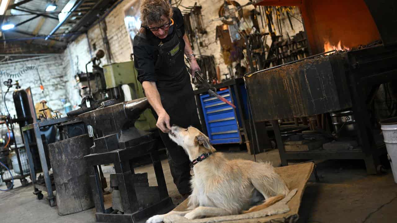 Steve Phillips with his dog Harry at Waterside Metal Art workshop