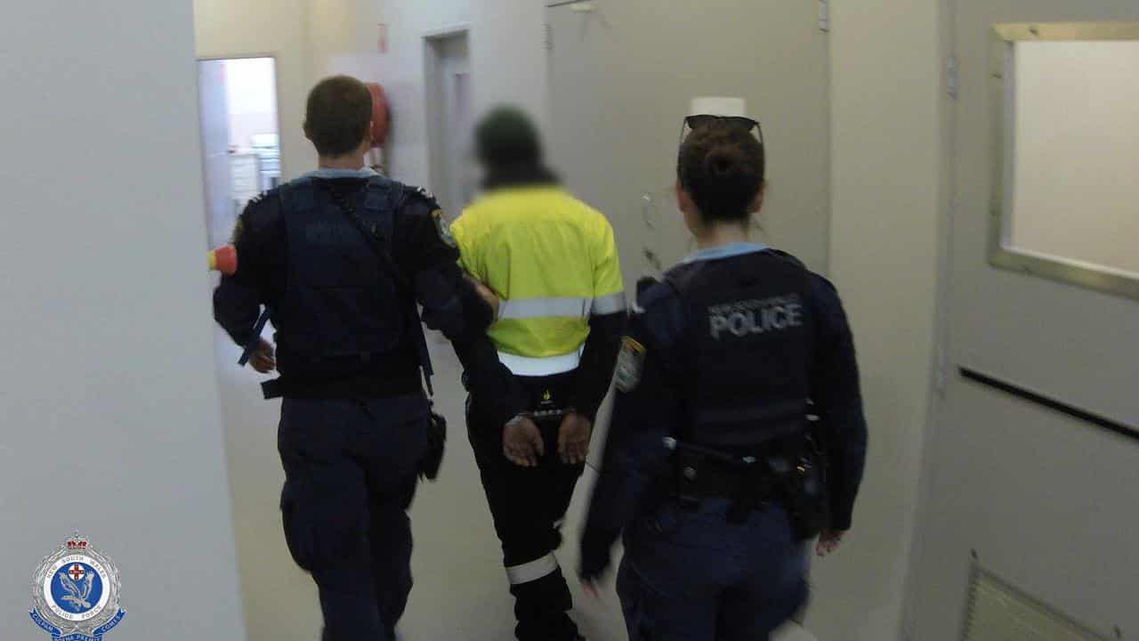 A Queensland man under arrest at Campbelltown Police Station