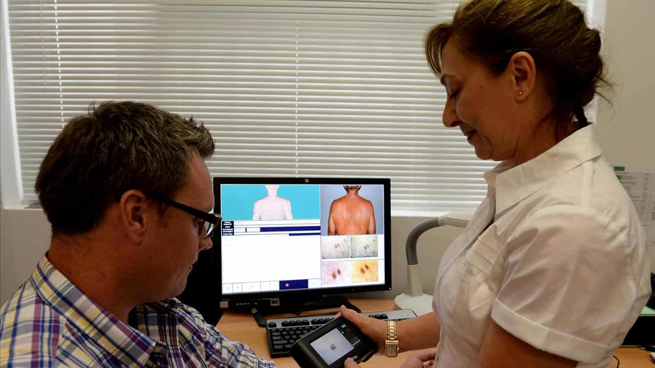 A patient being checked for skin cancers