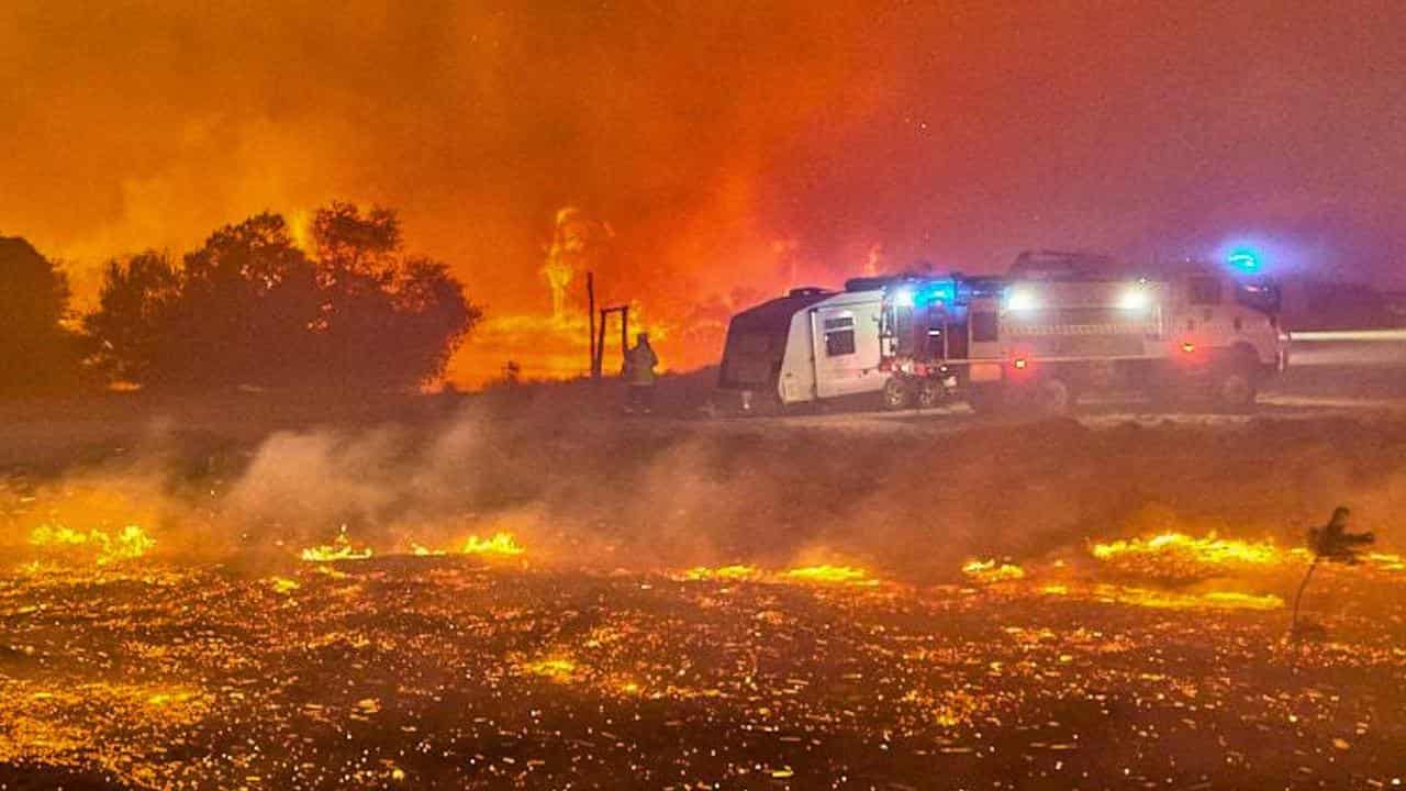 Fire surrounds a fire truck.