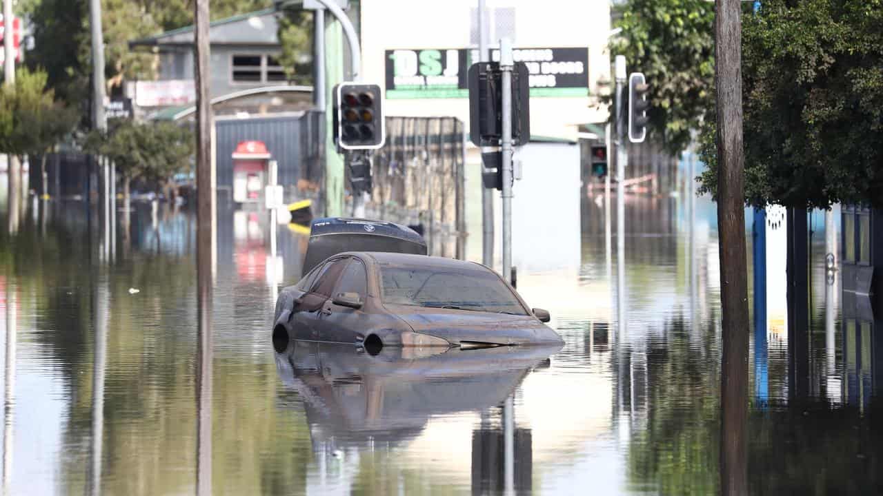 A car sits in floodwaters.