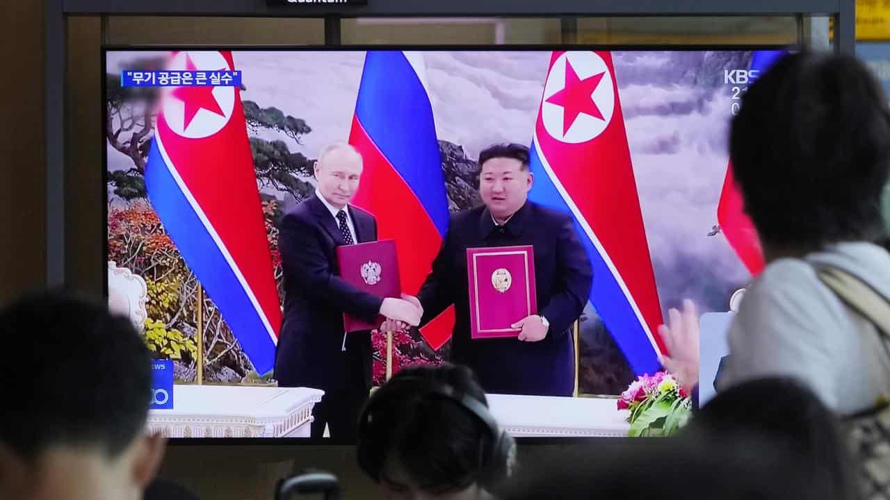 A TV in Seoul showing Vladimir Putin and Kim Jong-un in Pyongyang