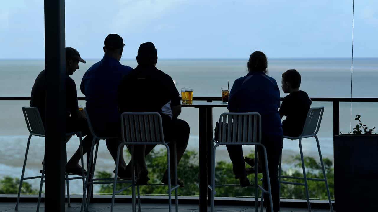 Tourists enjoy a drink