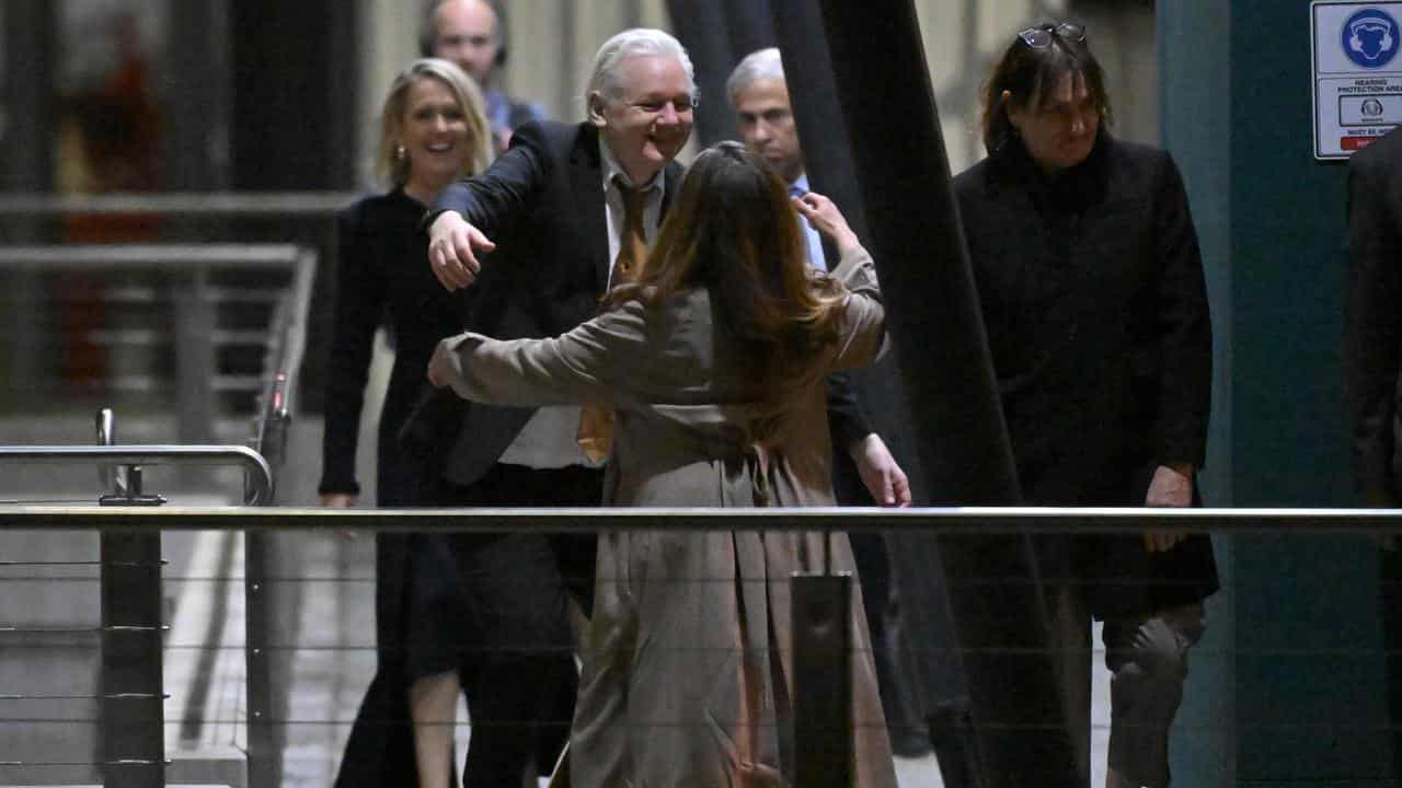 Julian Assange hugs wife Stella after arriving at Canberra Airport