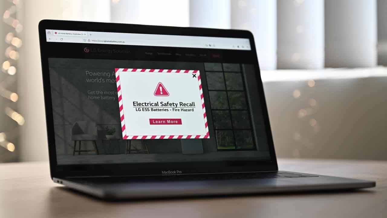 A laptop shows an 'Urgent Electrical Safety Recall' message