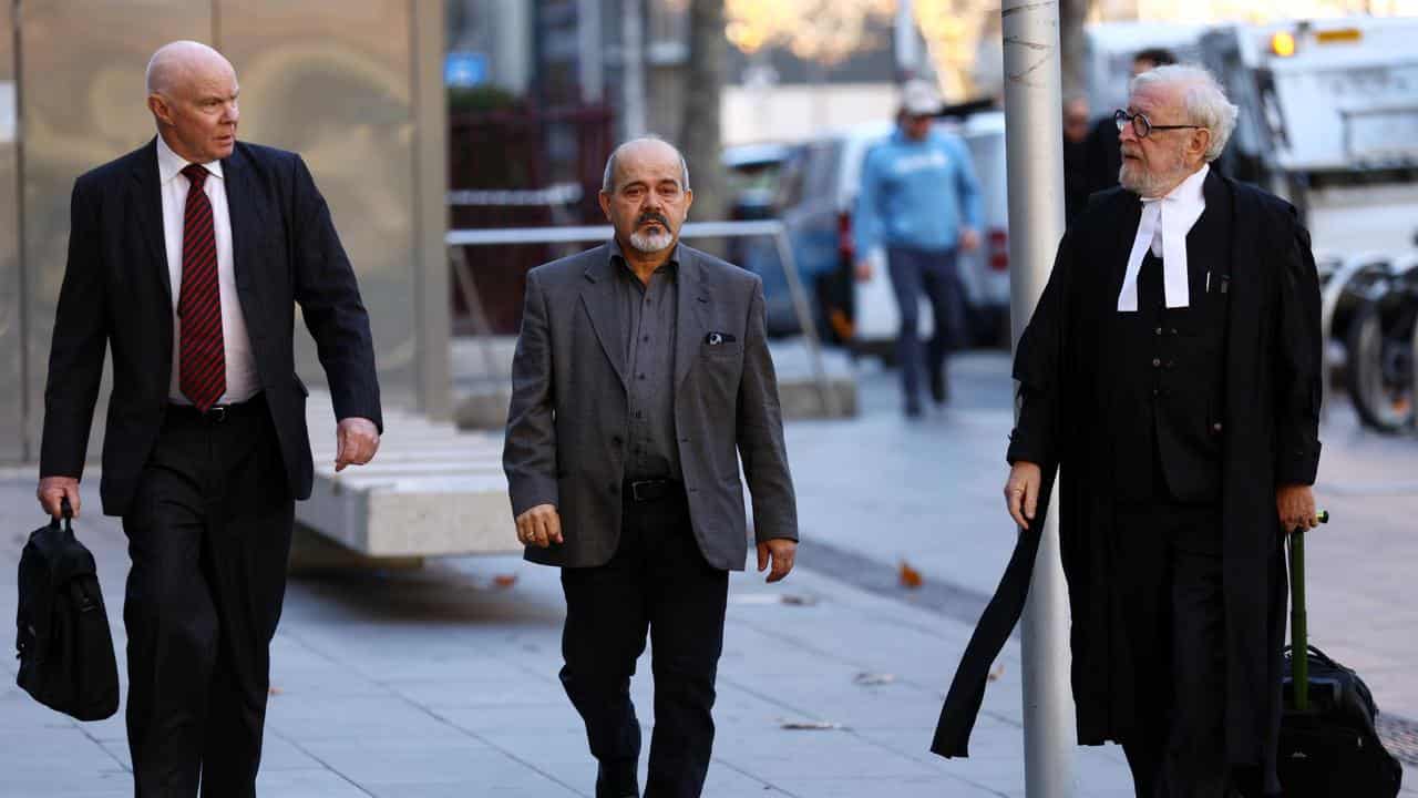 Milad El-Halabi (centre) arrives with lawyer Robert Richter (right)