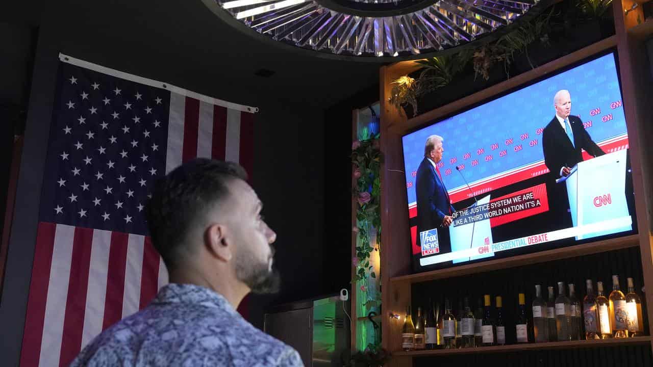 Man watches presidential debate on TV