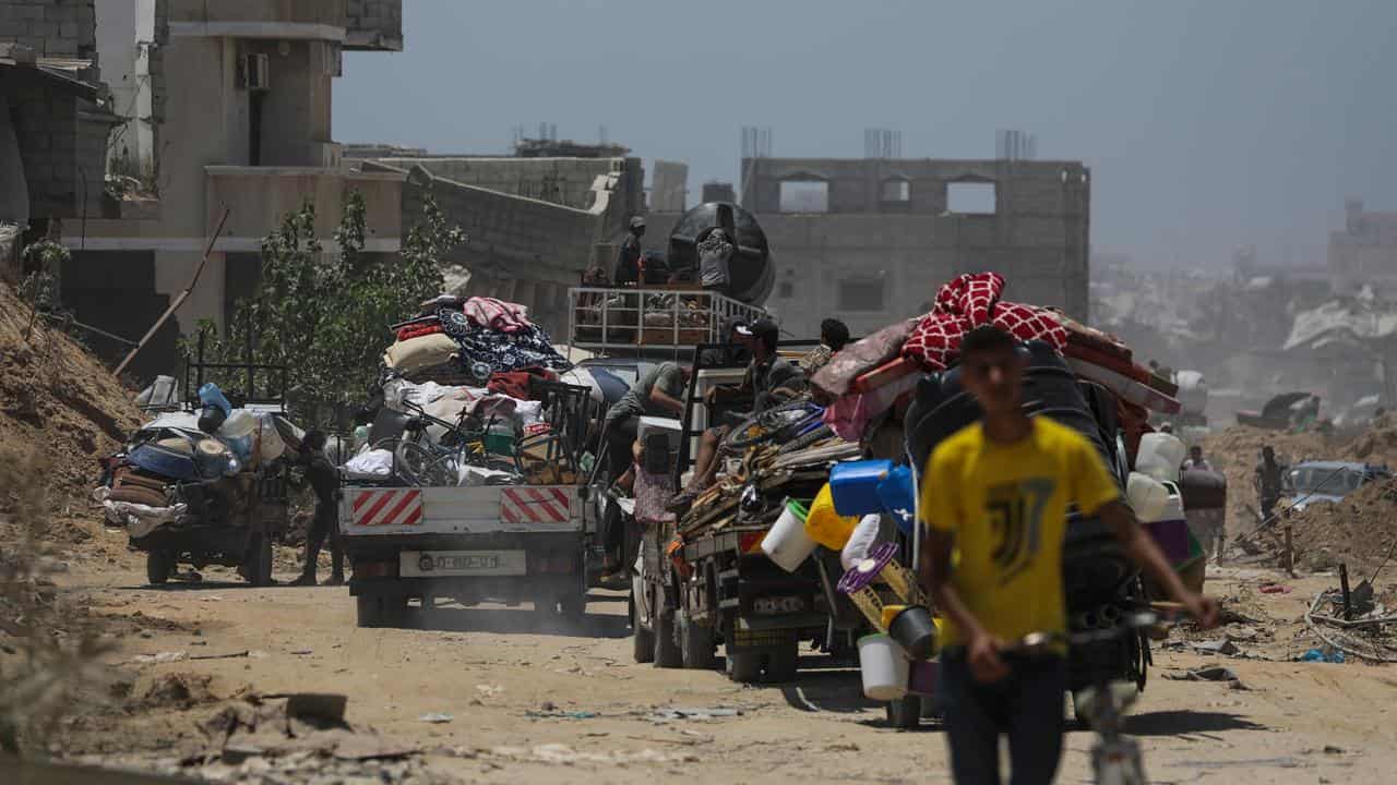 Palestinians leave following an evacuation order issued by Israel