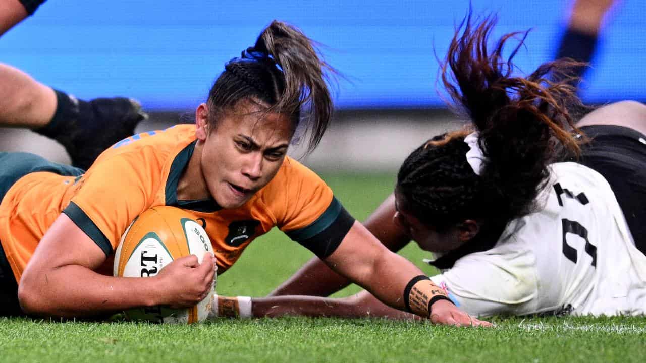 Trilleen Pomare scores a try for Australia. 