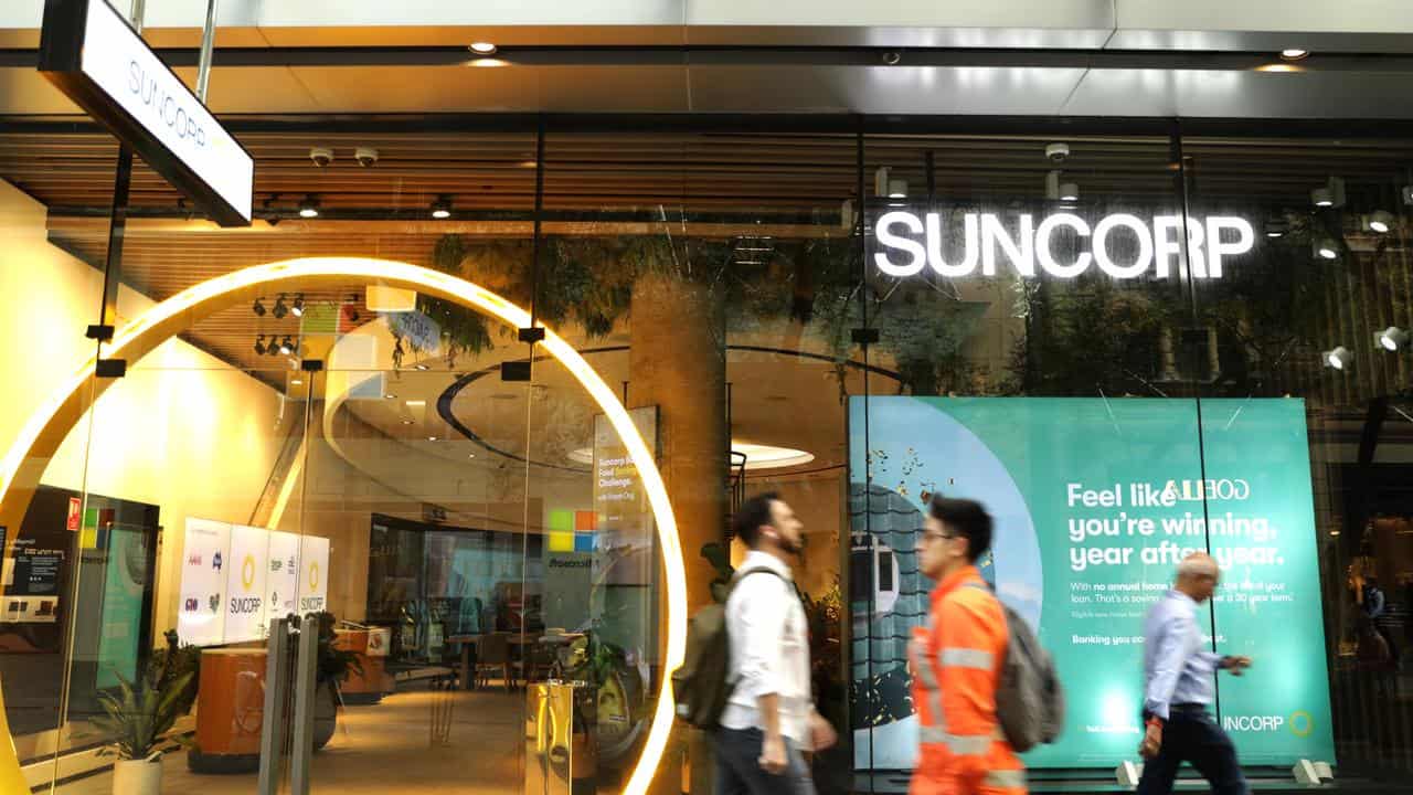 People walk past a Suncorp store in Sydney