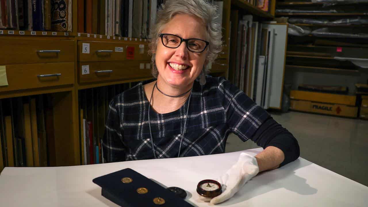 Fiona Salmon shows Matthew Flinders' compass and buttons.