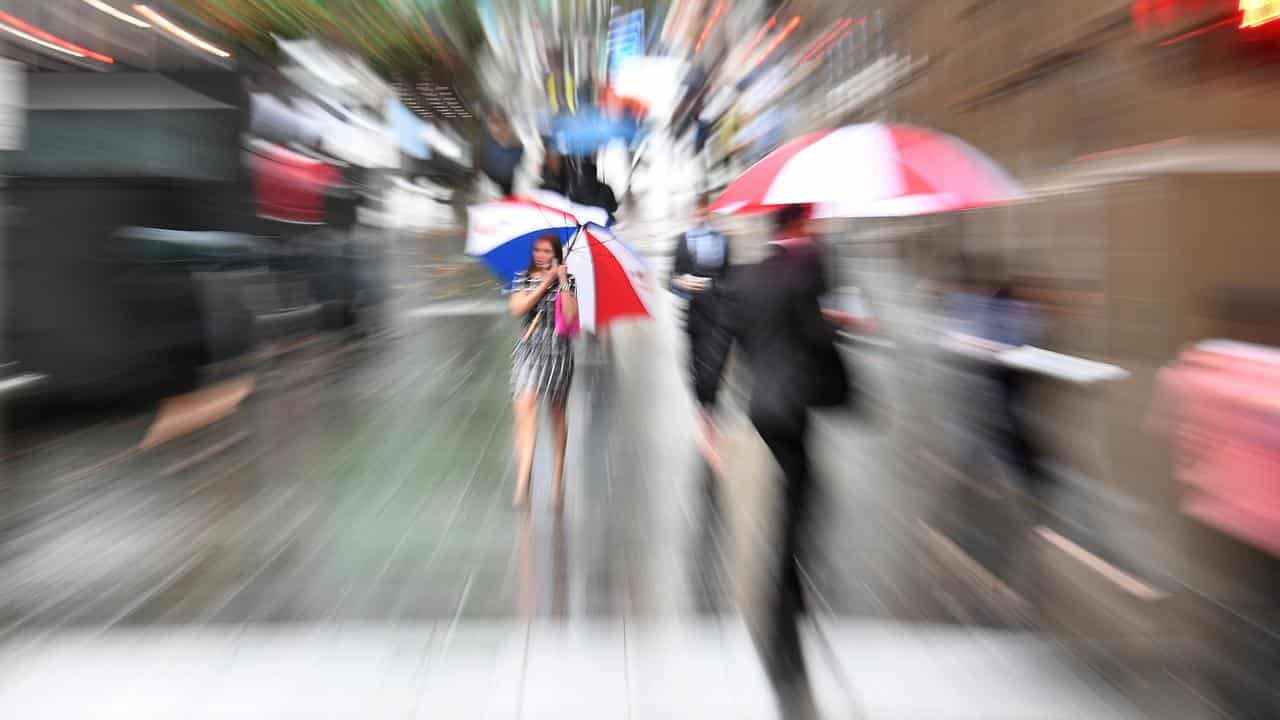 People are seen in the central business district of Sydney