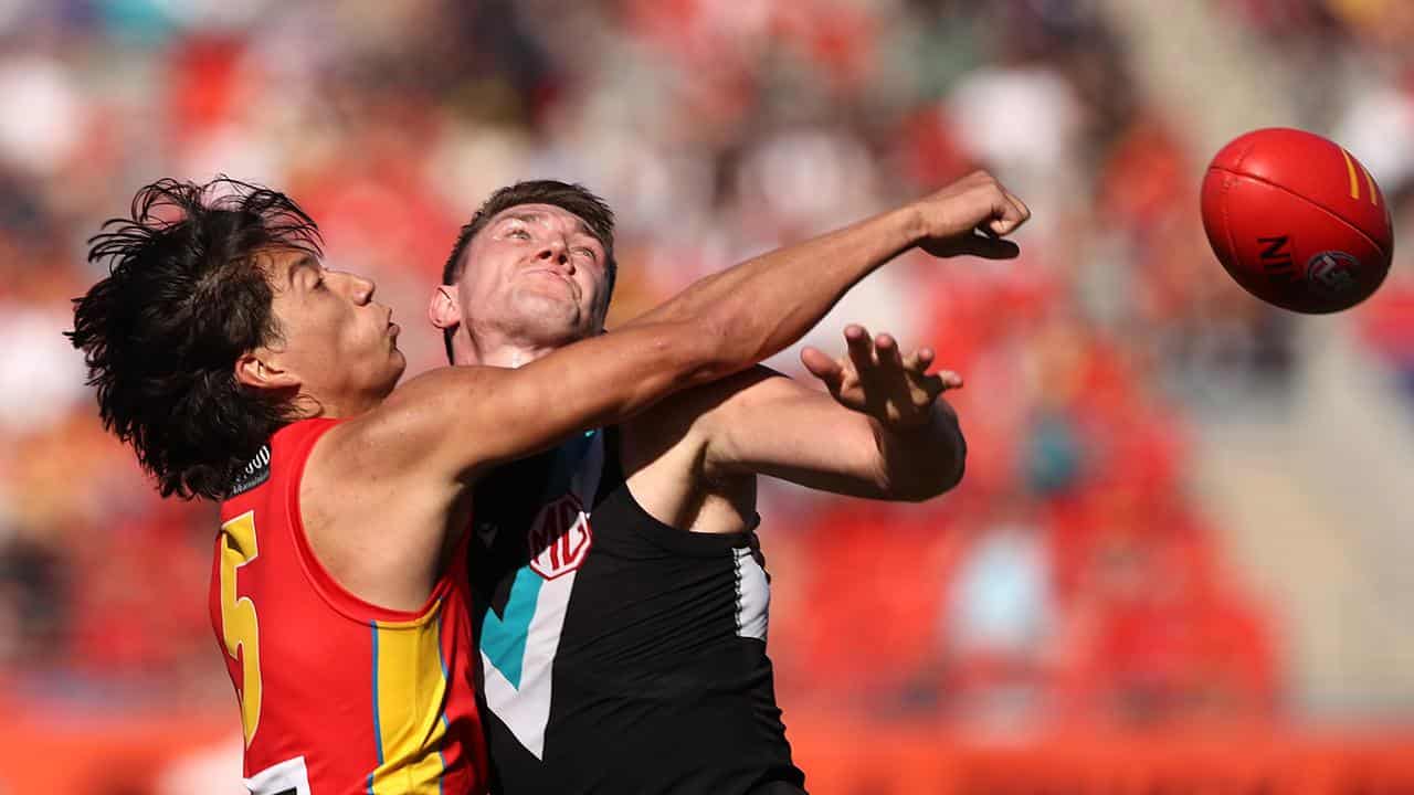 Gold Coast's Alex Davies (left) and  Port Adelaide's Jordon Sweet.