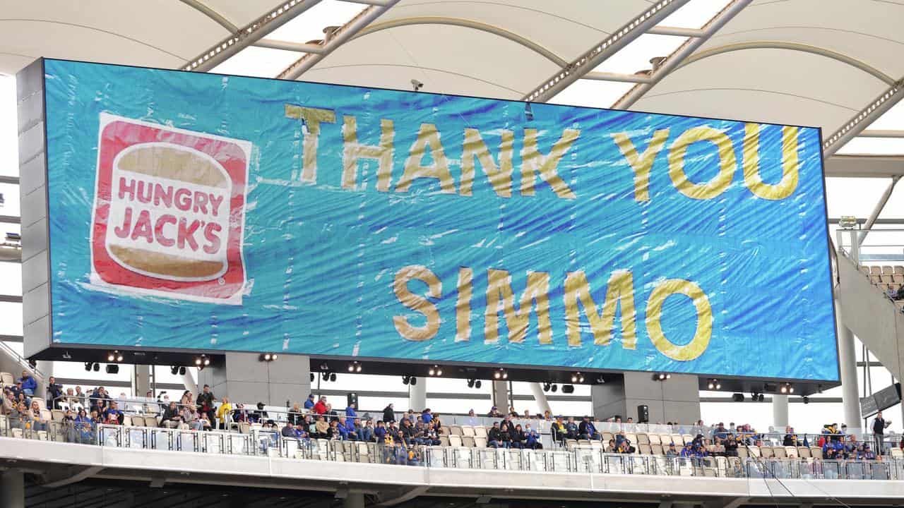 A message of then big screen thanking Adam Simpson.