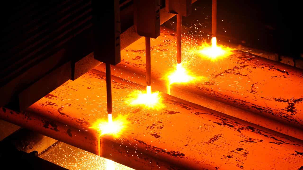 Heated steel being cut into slabs