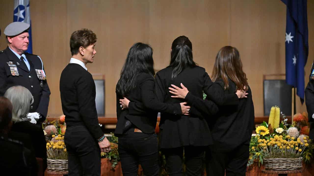 Family members place a wreath at an MH17 ceremony in Canberra