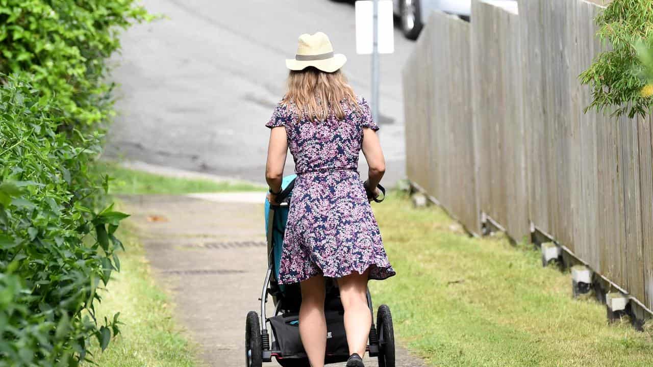 Mother pushes a stroller