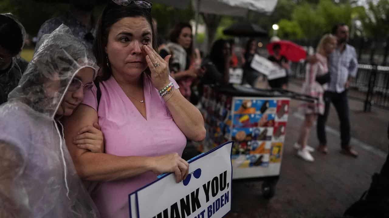 People listen in Lafayette Square to President Joe Biden's address