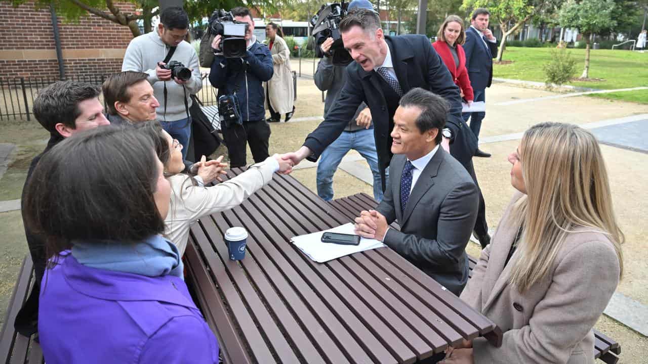 A group of people at an outdoor table.