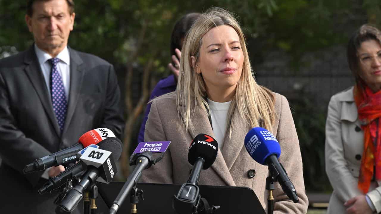 A woman speaks at a press conference.