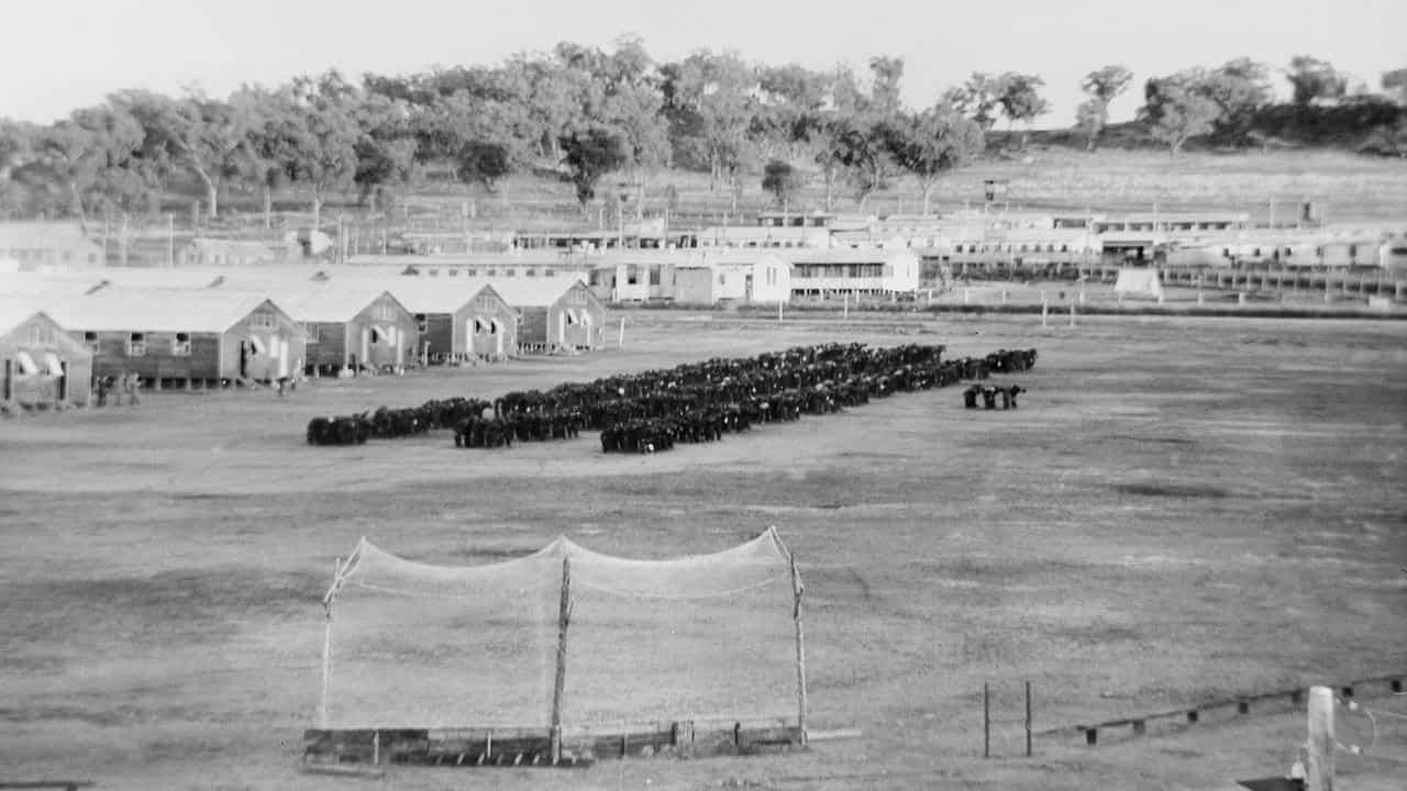 Japanese PoWs bow to the rising sun at the Cowra camp.