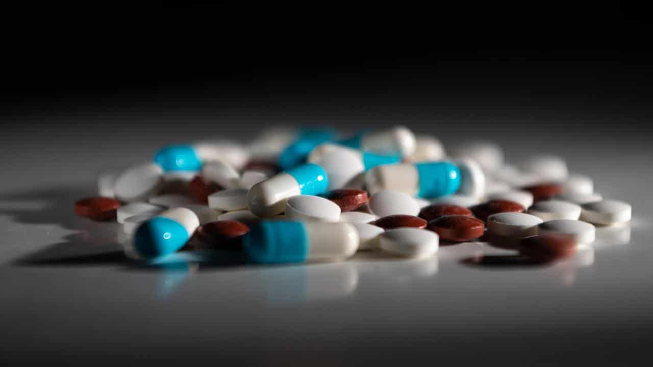 A pile of medicine tablets on a table