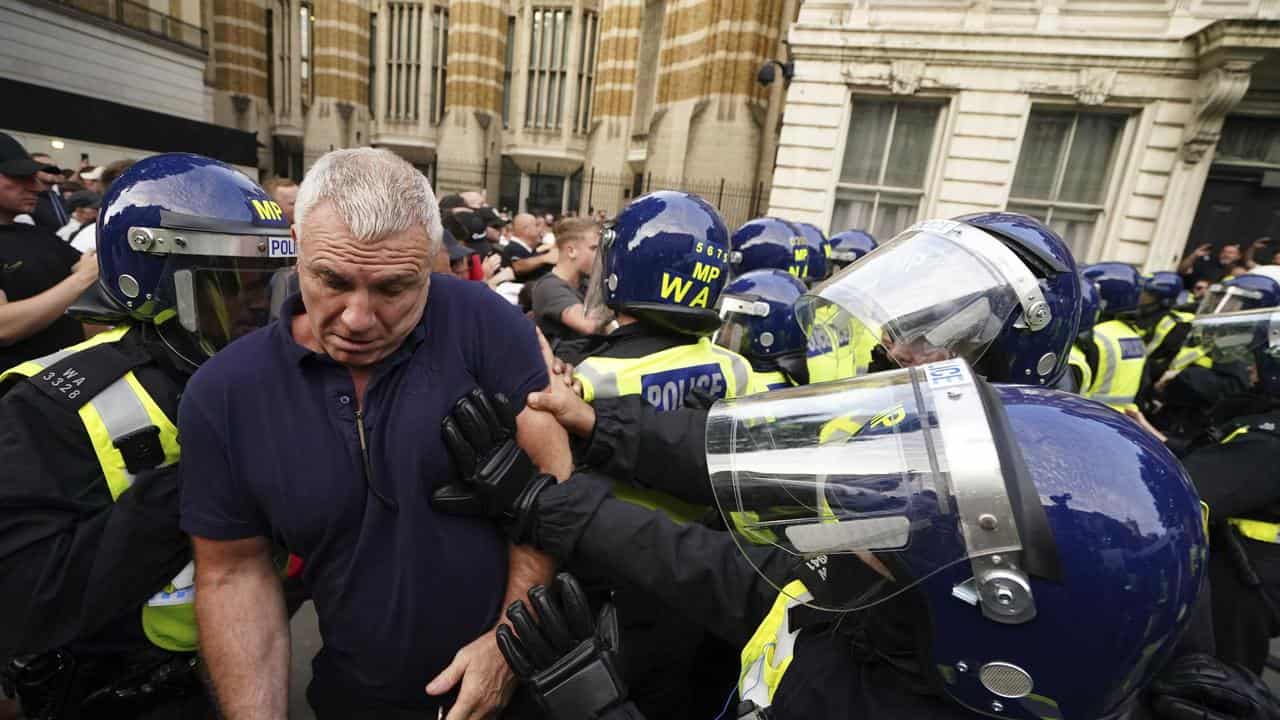 Officers scuffle with people at the Enough is Enough protest in London