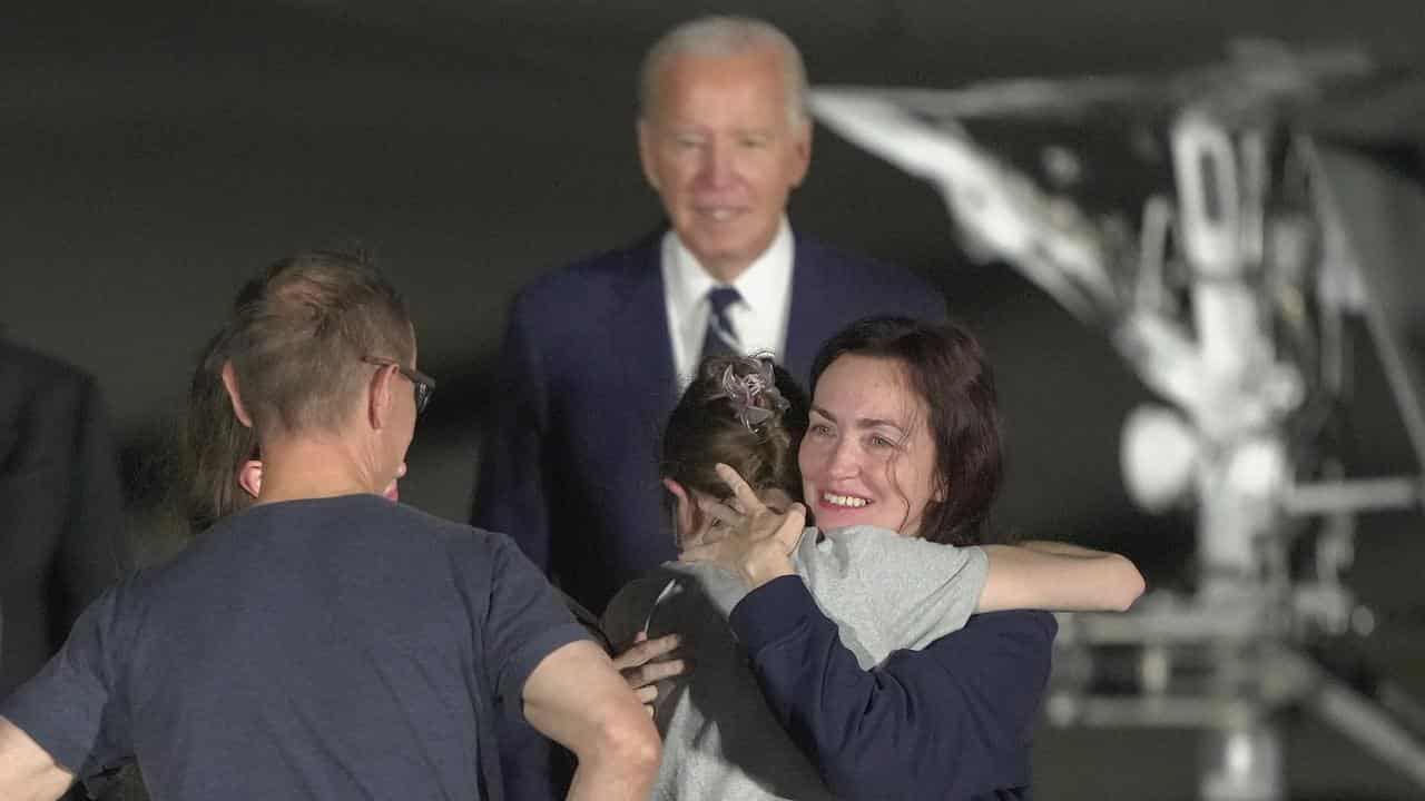 Alsu Kurmasheva hugs a family member at Andrews Air Force Base