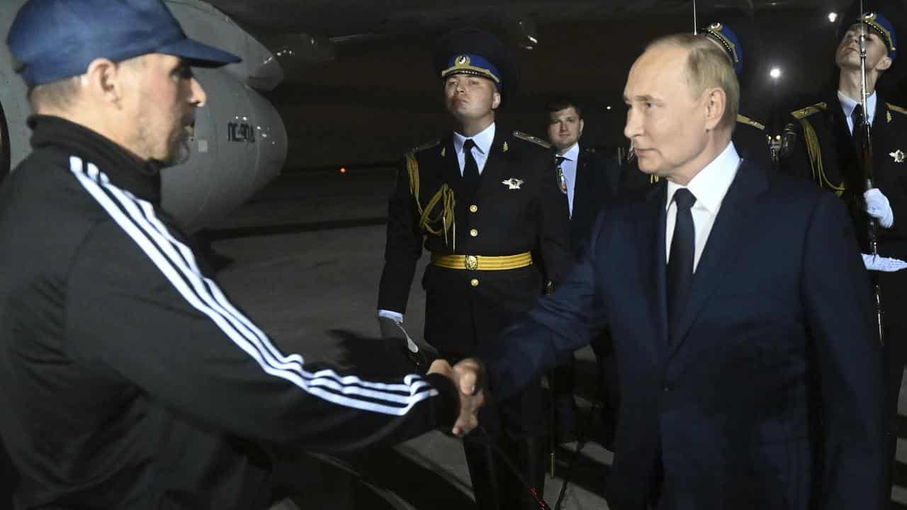 Russian President Vladimir Putin greets Vadim Krasikov on arrival