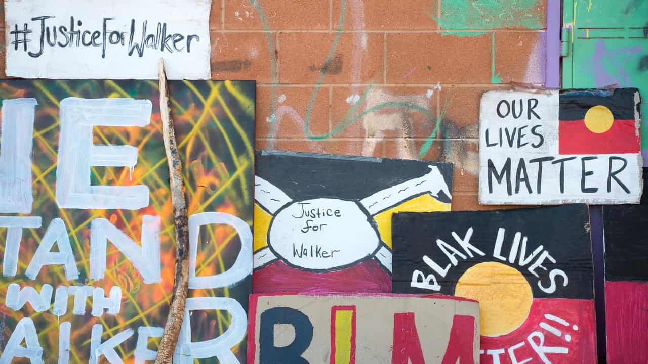 Protest signs in Yuendumu about Kumanjayi Walker's death.