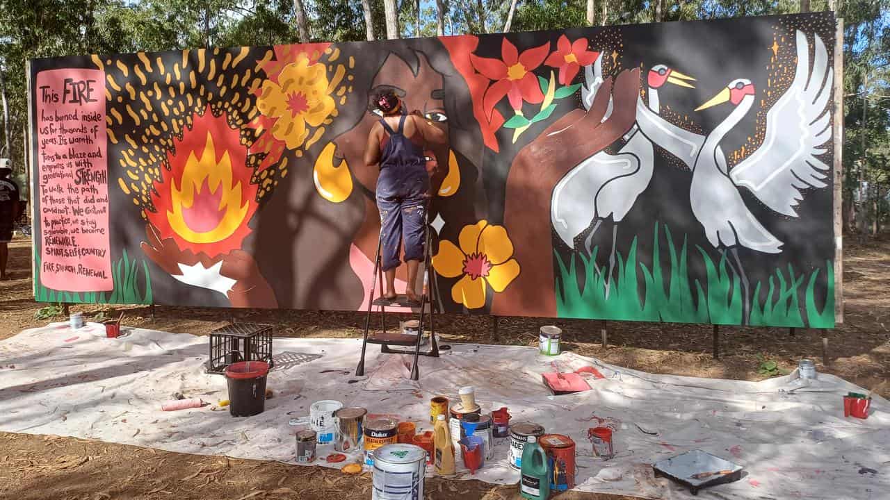 Artist Molly Hunt finishes her mural 