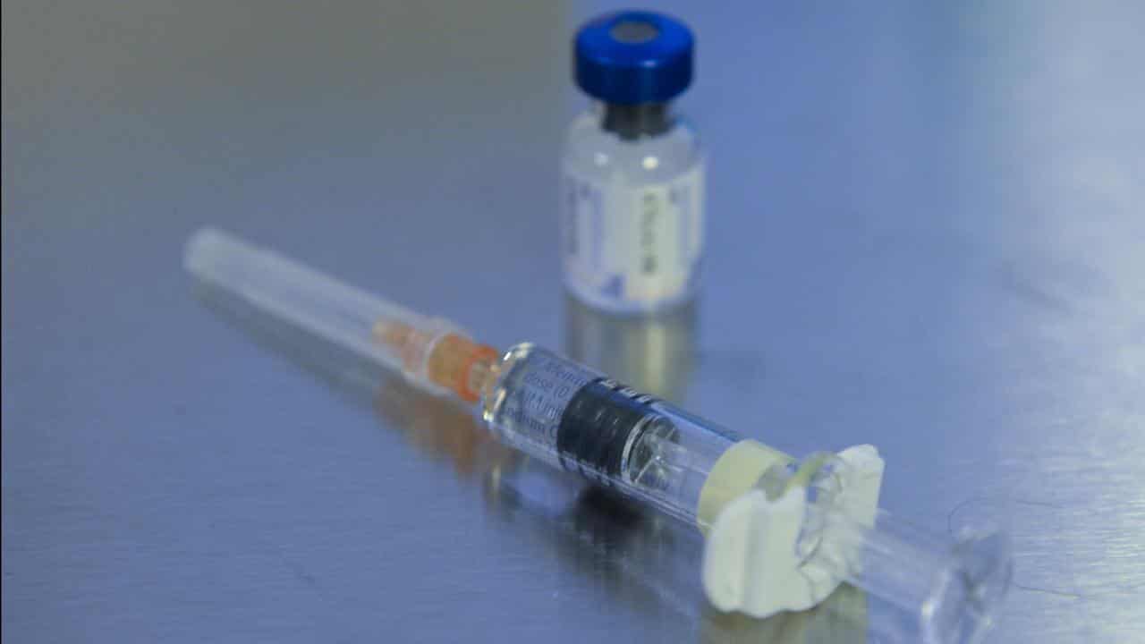 Close up of a vaccine and syringe.