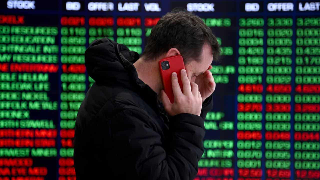 A man in front of the ASX board in Sydney