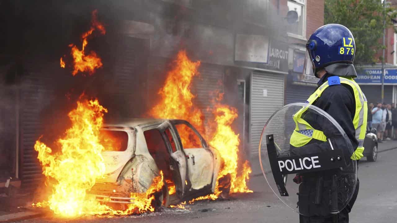 A car burns during an anti-immigration protest in Middlesbrough, UK