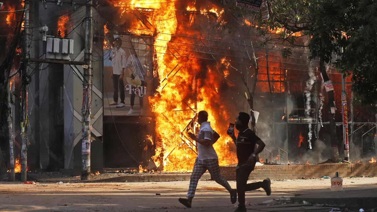 A building burns during an anti-government rally in Dhaka, Bangladesh