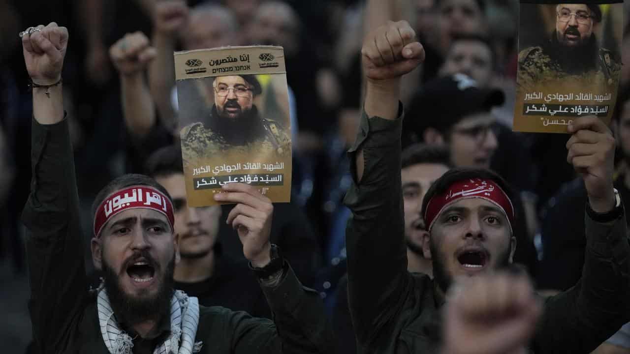 Hezbollah supporters with pictures of killed commander Fouad Shukur