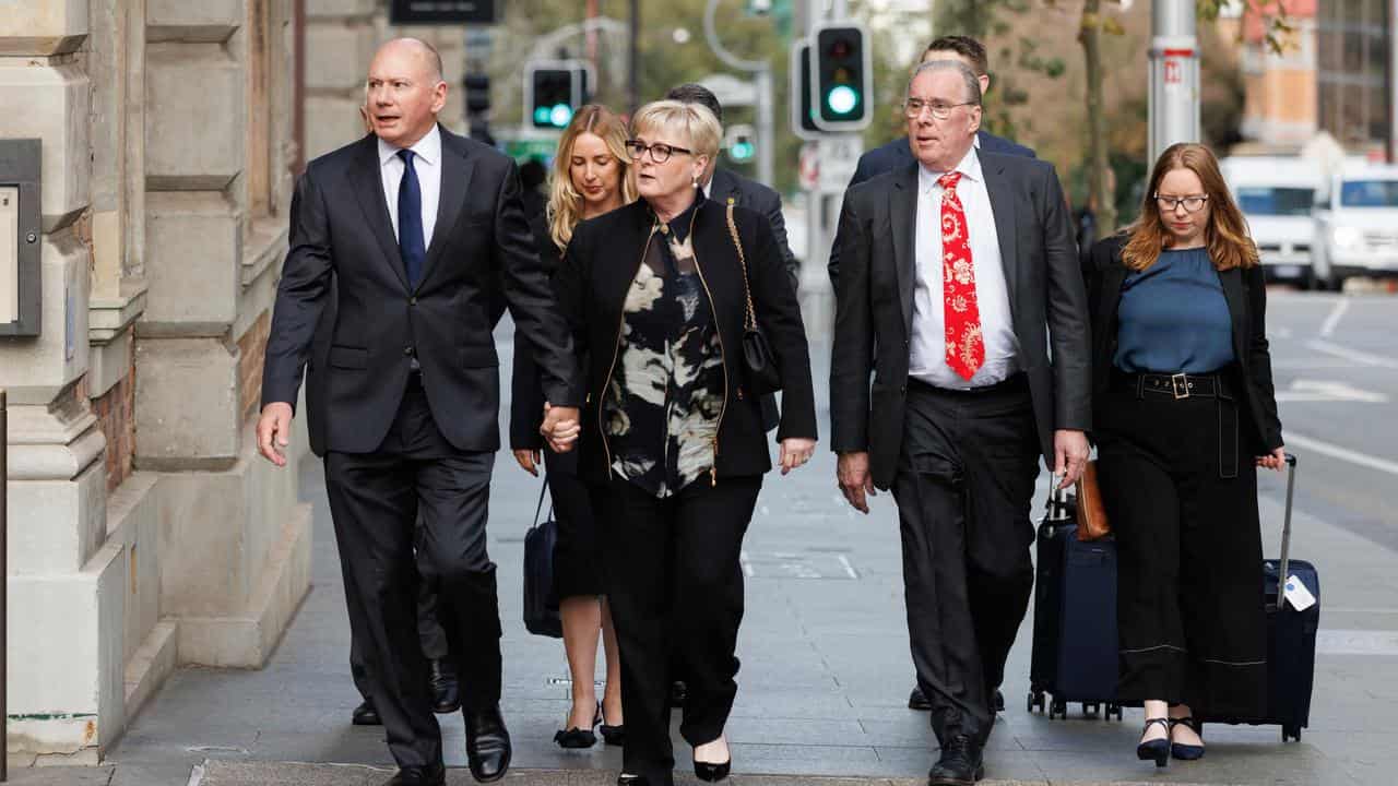 Senator Reynolds arrives at court with legal team and family