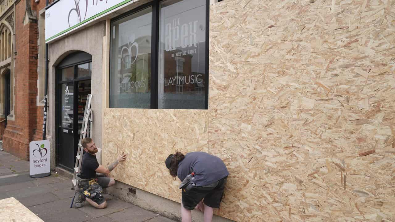 Windows are boarded up before a protest in Northampton, England