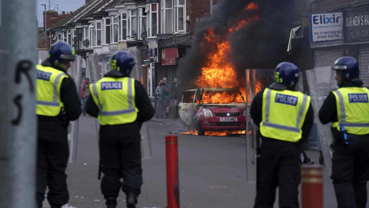 A car burns in an anti-immigration protest in Middlesbrough, England