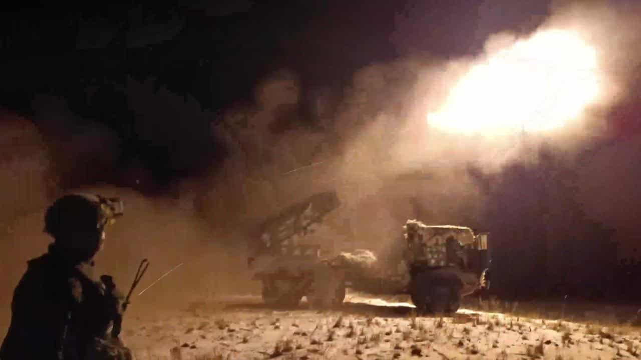 Russian soldiers fire from a 122mm multiple rocket launcher