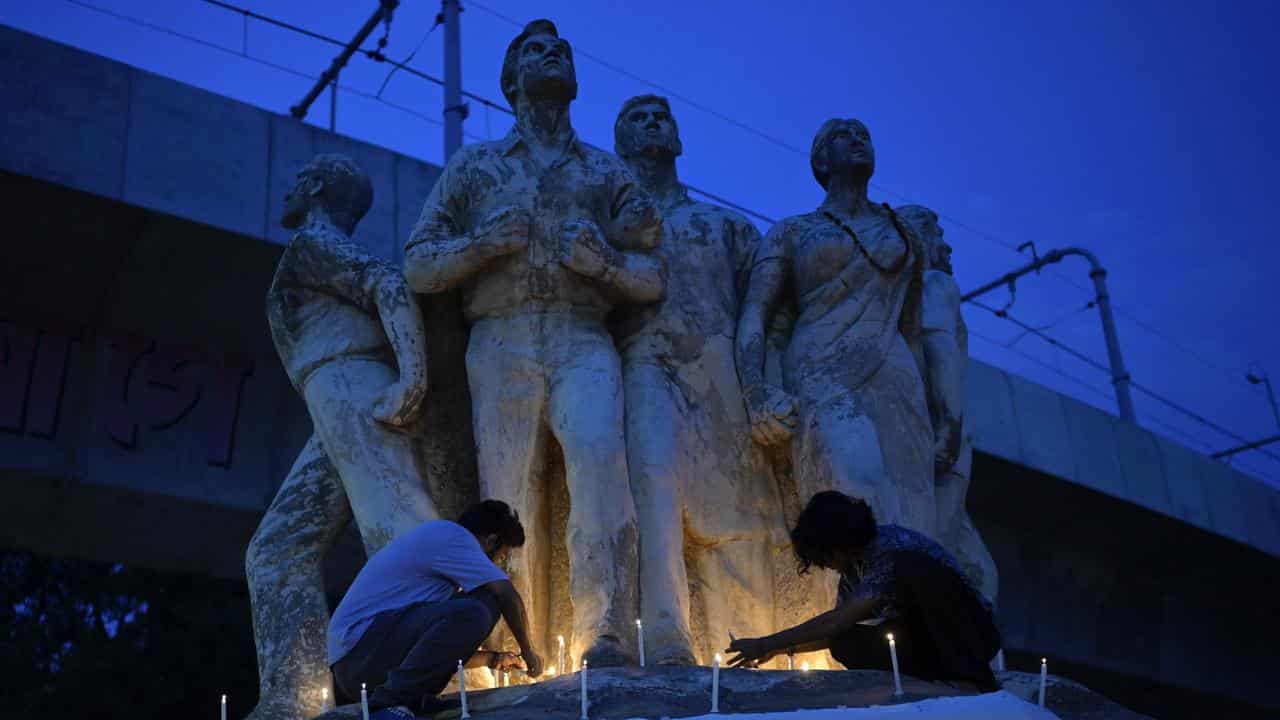 People take part in a candlelight vigil in Dhaka, Bangladesh